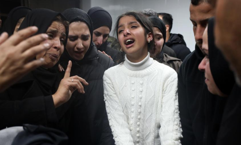 People mourn a Palestinian man killed by Israeli army gunfire at a hospital in the West Bank city of Nablus, on Jan. 4, 2025. A Palestinian was killed and eight others injured, including one critically, by Israeli army gunfire in a refugee camp in the northern West Bank city of Nablus on Friday, Palestinian authorities said. (Photo by Ayman Nobani/Xinhua)