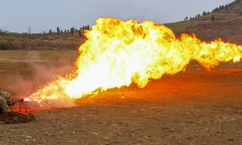 A flamethrower operator assigned to a chemical defense detachment of a brigade under the Chinese PLA Army fires at the simulated target on November 20, 2024. (eng.chinamil.com.cn/Photo by Liao Zhenxiong)