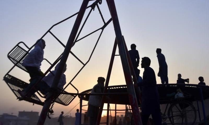 This photo taken on Dec. 31, 2024 shows the silhouettes of children having fun at sunset in northwest Pakistan's Peshawar. (Photo by Saeed Ahmad/Xinhua)