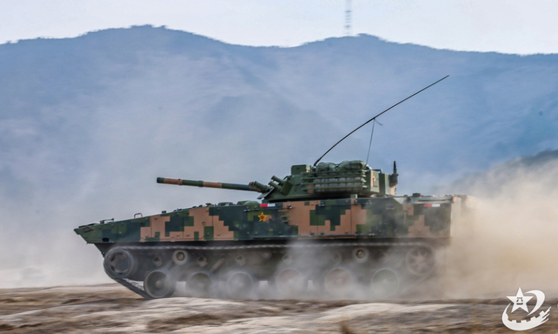 An infantry fighting vehicle (IFV) attached to a brigade under the Chinese PLA 71st Group Army kicks up plumes of dust during a maneuver training exercise on December 11, 2024. (eng.chinamil.com.cn/Photo by Lin Min)