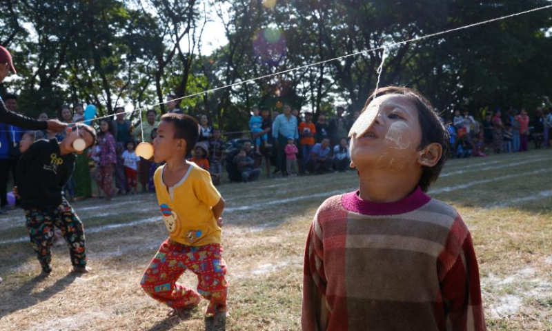 Children compete in a cookie-biting game during an event marking the 77th Anniversary of Independence Day in Nay Pyi Taw, Myanmar, Jan. 4, 2025. Myanmar on Saturday celebrated the 77th Anniversary of Independence Day with various events being held across the country. (Xinhua/Myo Kyaw Soe)