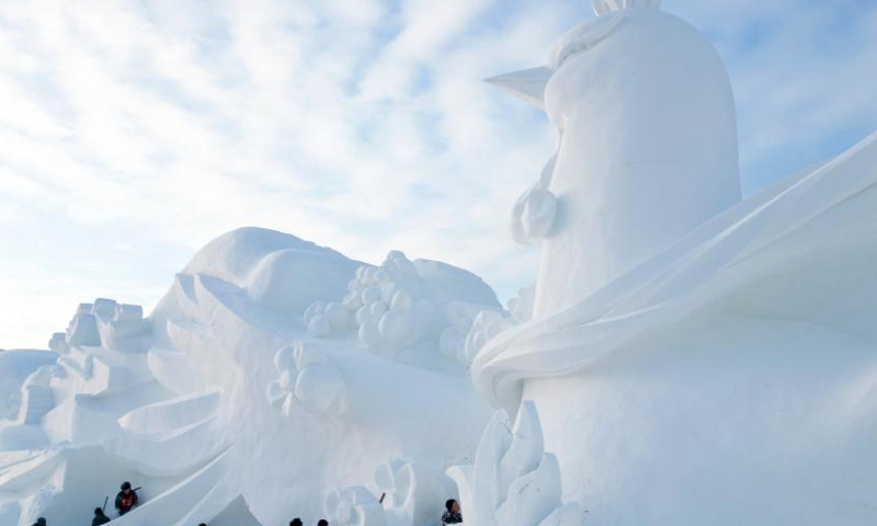 In this aerial drone photo, sculptors work on a giant snow sculpture at the 37th Sun Island International Snow Sculpture Expo in Harbin, northeast China's Heilongjiang Province, Dec. 23, 2024. The 37th Sun Island International Snow Sculpture Expo began its trial operation here Monday. (Xinhua/Zhang Tao)