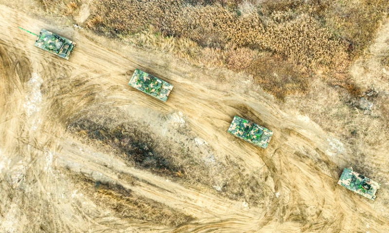 Armored vehicles attached to a brigade under the Chinese PLA 71st Group Army march towards the designated area during a maneuver training exercise on December 11, 2024. (eng.chinamil.com.cn/Photo by Lin Min)