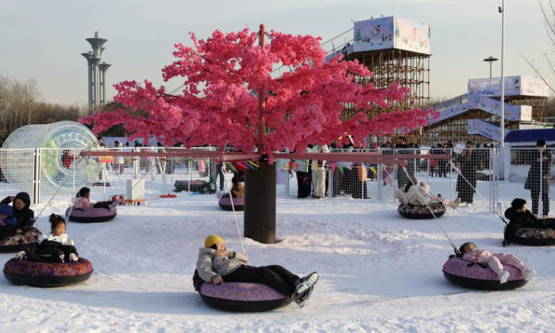 People enjoy themselves at the National Speed Skating Oval in Beijing, capital of China, Jan. 4, 2025. People flocked to the National Speed Skating Oval to have fun with ice and snow during the weekend. (Xinhua/Zhang Chenlin)