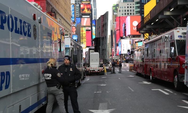 Police officers stand guard in Times Square in New York City, the United States, on Dec. 31, 2024. New York State Governor Kathy Hochul on Monday announced increased security measures statewide to ensure public safety during holiday celebrations. (Xinhua/Liu Yanan)