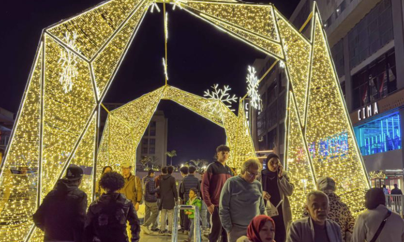 People walk through a festive decoration at a shopping area in Cairo, Egypt, on Dec. 23, 2024. (Xinhua/Ahmed Gomaa)