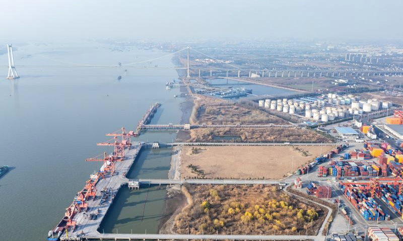 An aerial drone photo shows a view of Taizhou Port in east China's Jiangsu Province, Jan. 2, 2025. China's major ports are busy at the beginning of the new year. (Photo by Zhou Shegen/Xinhua)