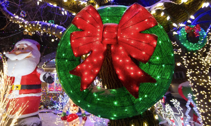 Colorful lights and decorations are seen outside a residential house in Mississauga, Ontario, Canada, on Dec. 23, 2024. (Photo by Zou Zheng/Xinhua)