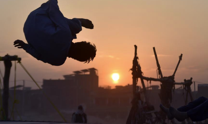 This photo taken on Dec. 31, 2024 shows the silhouette of a boy playing on a trampoline at sunset in northwest Pakistan's Peshawar. (Photo by Saeed Ahmad/Xinhua)