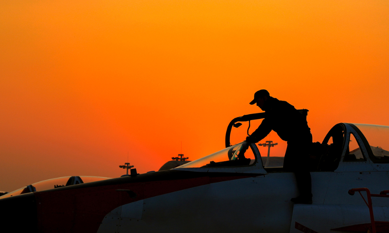 A maintenance man assigned to a regiment of the Chinese PLA Naval Aviation University conducts pre-flight inspections on a jet trainer during a flight training exercise in late November, 2024. (eng.chinamil.com.cn/Photo by Lan Pengfei)