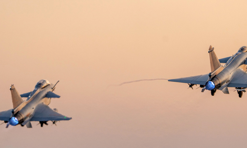 Two J-10 fighter jets attached to an aviation brigade with the air force under the Chinese PLA Southern Theater Command take off in formation during a flight training exercise in late November, 2024. (eng.chinamil.com.cn/Photo by Wang Guoyun)