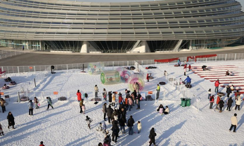 People enjoy themselves at the National Speed Skating Oval in Beijing, capital of China, Jan. 4, 2025. People flocked to the National Speed Skating Oval to have fun with ice and snow during the weekend. (Xinhua/Zhang Chenlin)