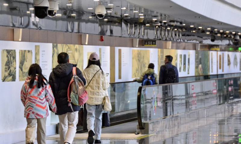 Passengers pass through an art corridor at the Beijing Daxing International Airport, in Beijing, capital of China, Jan. 4, 2025. (Xinhua/Li Xin)