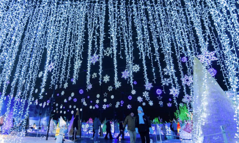 People visit a light show in Mississauga, Ontario, Canada, on Dec. 24, 2024.

Featuring 16 magical-themed exhibition areas, the outdoor light show named The Holidays At Illumi kicked off here on Nov. 15, 2024, and will last until Jan. 5, 2025. (Photo by Zou Zheng/Xinhua)