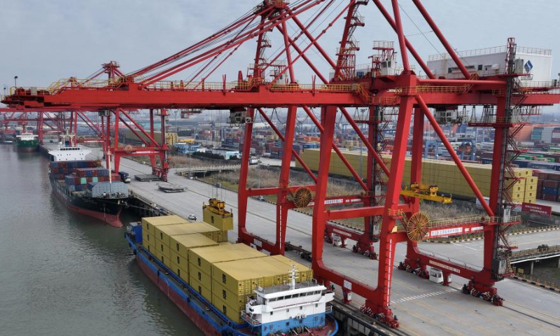 An aerial drone photo shows a view of the container terminal of Nanjing Port in east China's Jiangsu Province, Jan. 1, 2025. China's major ports are busy at the beginning of the new year. (Photo by Xin Yi/Xinhua)