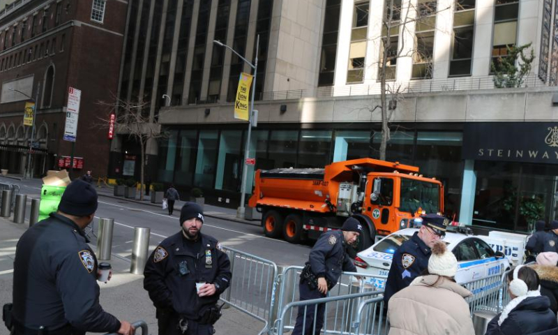 Police officers stand guard on a street close to Times Square in New York City, the United States, on Dec. 31, 2024. New York State Governor Kathy Hochul on Monday announced increased security measures statewide to ensure public safety during holiday celebrations. (Xinhua/Liu Yanan)