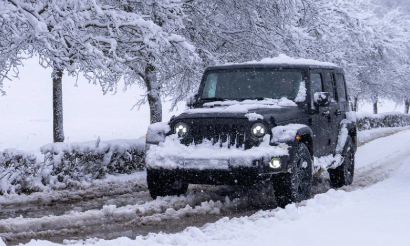 A jeep runs on a road in the snow in Otocac, Croatia, on Dec. 23, 2024. (Hrvoje Kostelac/PIXSELL via Xinhua)