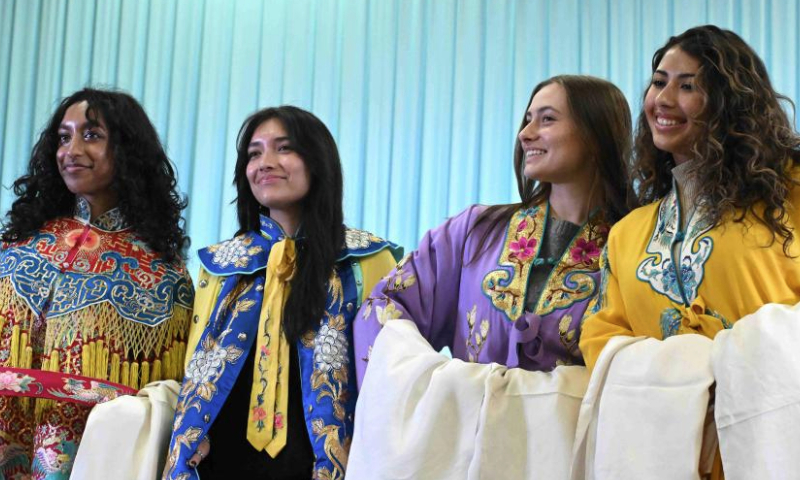 U.S. college students pose for photos in Peking Opera costumes in Shijiazhuang, north China's Hebei Province, Dec. 30, 2024. At the invitation of Shijiazhuang Foreign Language School, a group of U.S. teachers and students visit Shijiazhuang from Dec. 25 to Dec. 31. (Photo by Chen Qibao/Xinhua)