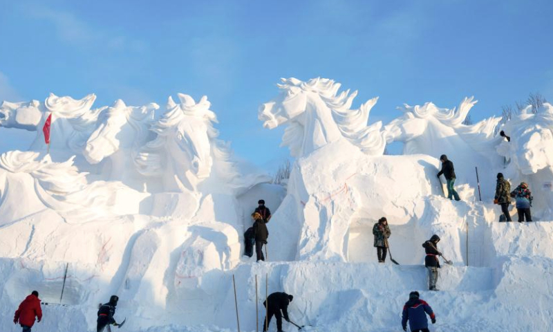 Sculptors work on a giant snow sculpture at the 37th Sun Island International Snow Sculpture Expo in Harbin, northeast China's Heilongjiang Province, Dec. 23, 2024. The 37th Sun Island International Snow Sculpture Expo began its trial operation here Monday. (Xinhua/Zhang Tao)