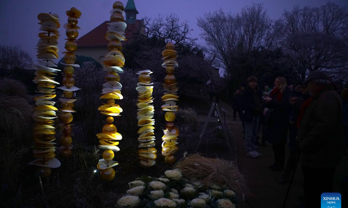 People view luminous glass flower installations during the exhibition of Crystal Garden - Light and Glass in Fantastic Installations at the Prague Botanical Garden in Prague, the Czech Republic, on Dec. 27, 2024. The exhibition, a harmonious blend of light and glass, will run until Feb. 2, 2025. (Photo: Xinhua)