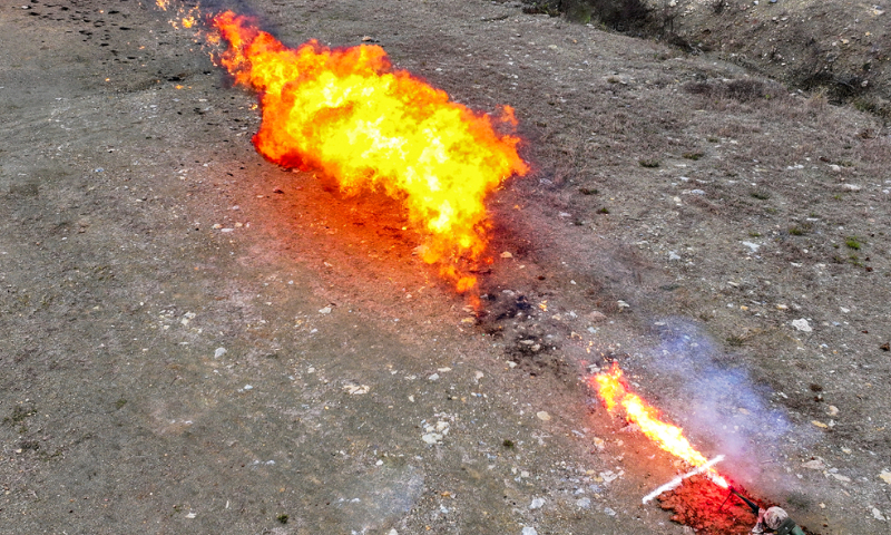 A flamethrower operator assigned to a chemical defense detachment of a brigade under the Chinese PLA Army fires at the simulated target on November 20, 2024. (eng.chinamil.com.cn/Photo by Liao Zhenxiong)