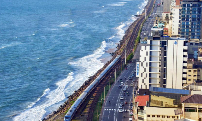 This photo taken on Dec. 23, 2024 shows a train by the sea in Colombo, Sri Lanka.

The coastal railway line, located on the west coast of Sri Lanka and close to the Indian Ocean, is a major railway line in this island country. It is also a famous tourist attraction, where the straight coastline, the carriages without doors, and the beautiful sea view throughout the journey allow people to get the unique Ceylon-style experience. (Photo by Gayan Sameera/Xinhua)