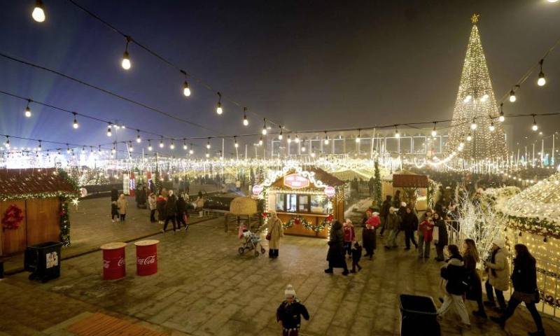 People visit a New Year market at Ala Too Square in Bishkek, Kyrgyzstan, Dec. 23, 2024. (Photo by Roman Gainanov/Xinhua)