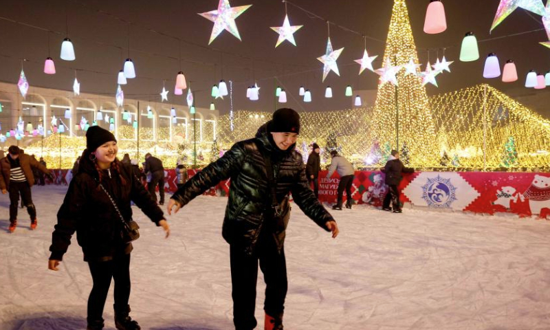 People skate at Ala Too Square during a New Year event in Bishkek, Kyrgyzstan, Dec. 23, 2024. (Photo by Roman Gainanov/Xinhua)