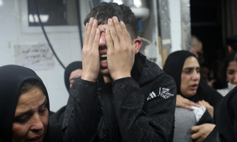 People mourn a Palestinian man killed by Israeli army gunfire at a hospital in the West Bank city of Nablus, on Jan. 4, 2025. A Palestinian was killed and eight others injured, including one critically, by Israeli army gunfire in a refugee camp in the northern West Bank city of Nablus on Friday, Palestinian authorities said. (Photo by Ayman Nobani/Xinhua)