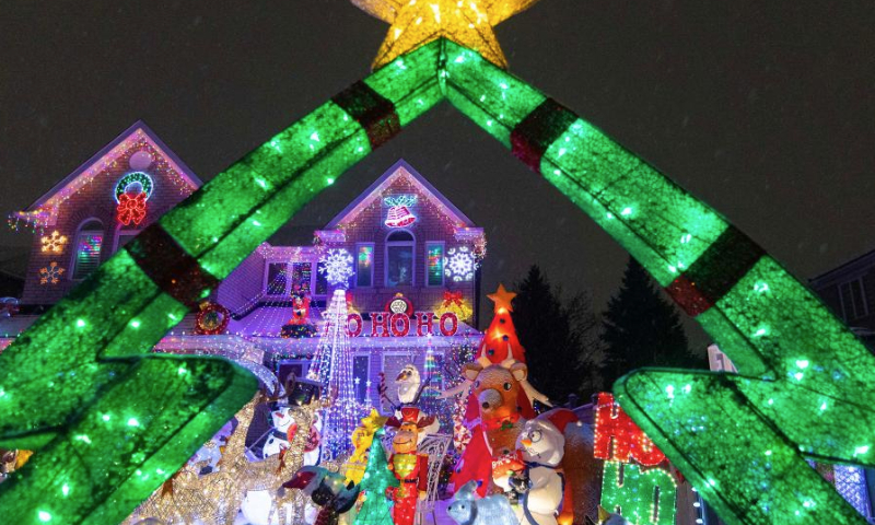 Colorful lights and decorations are seen outside a residential house in Mississauga, Ontario, Canada, on Dec. 23, 2024. (Photo by Zou Zheng/Xinhua)