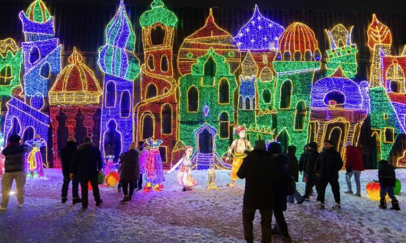 People visit a light show in Mississauga, Ontario, Canada, on Dec. 24, 2024.

Featuring 16 magical-themed exhibition areas, the outdoor light show named The Holidays At Illumi kicked off here on Nov. 15, 2024, and will last until Jan. 5, 2025. (Photo by Zou Zheng/Xinhua)