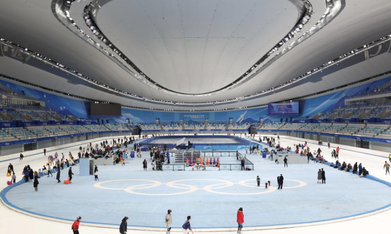 People enjoy themselves at the National Speed Skating Oval in Beijing, capital of China, Jan. 4, 2025. People flocked to the National Speed Skating Oval to have fun with ice and snow during the weekend. (Xinhua/Zhang Chenlin)