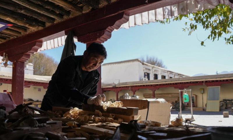 A craftsman from the maintenance unit of the Potala Palace's management office processes wooden parts needed in refurbishment of the palace in Lhasa, southwest China's Xizang Autonomous Region, Dec. 4, 2024. (Xinhua/Jigme Dorje)