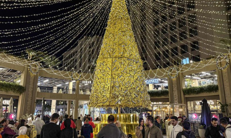 People are seen around a festive decoration at a shopping area in Cairo, Egypt, on Dec. 23, 2024. (Xinhua/Ahmed Gomaa)