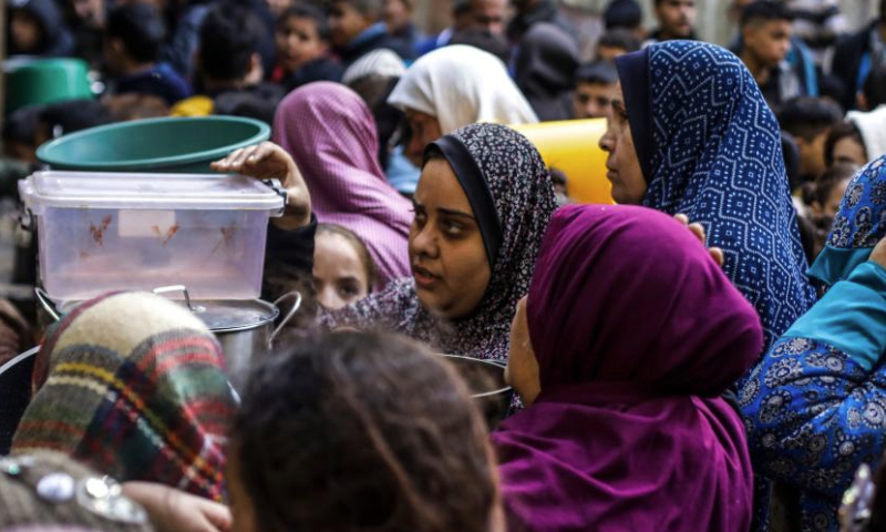 Palestinians receive free food from food distribution center in Gaza City