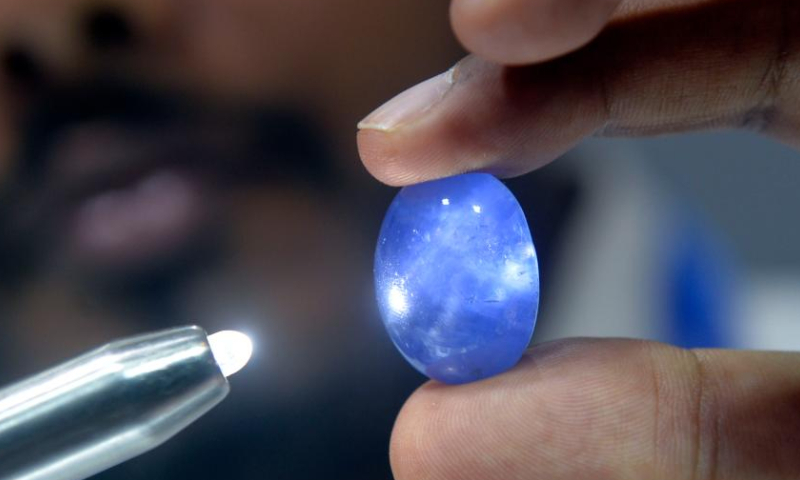 A man checks a gemstone on display during FACETS Sri Lanka 2025, an international gem and jewellery exhibition, in Colombo, Sri Lanka, Jan. 4, 2025. The exhibition opened here Saturday. (Photo by Gayan Sameera/Xinhua)

