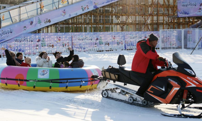 People enjoy themselves at the National Speed Skating Oval in Beijing, capital of China, Jan. 4, 2025. People flocked to the National Speed Skating Oval to have fun with ice and snow during the weekend. (Xinhua/Zhang Chenlin)