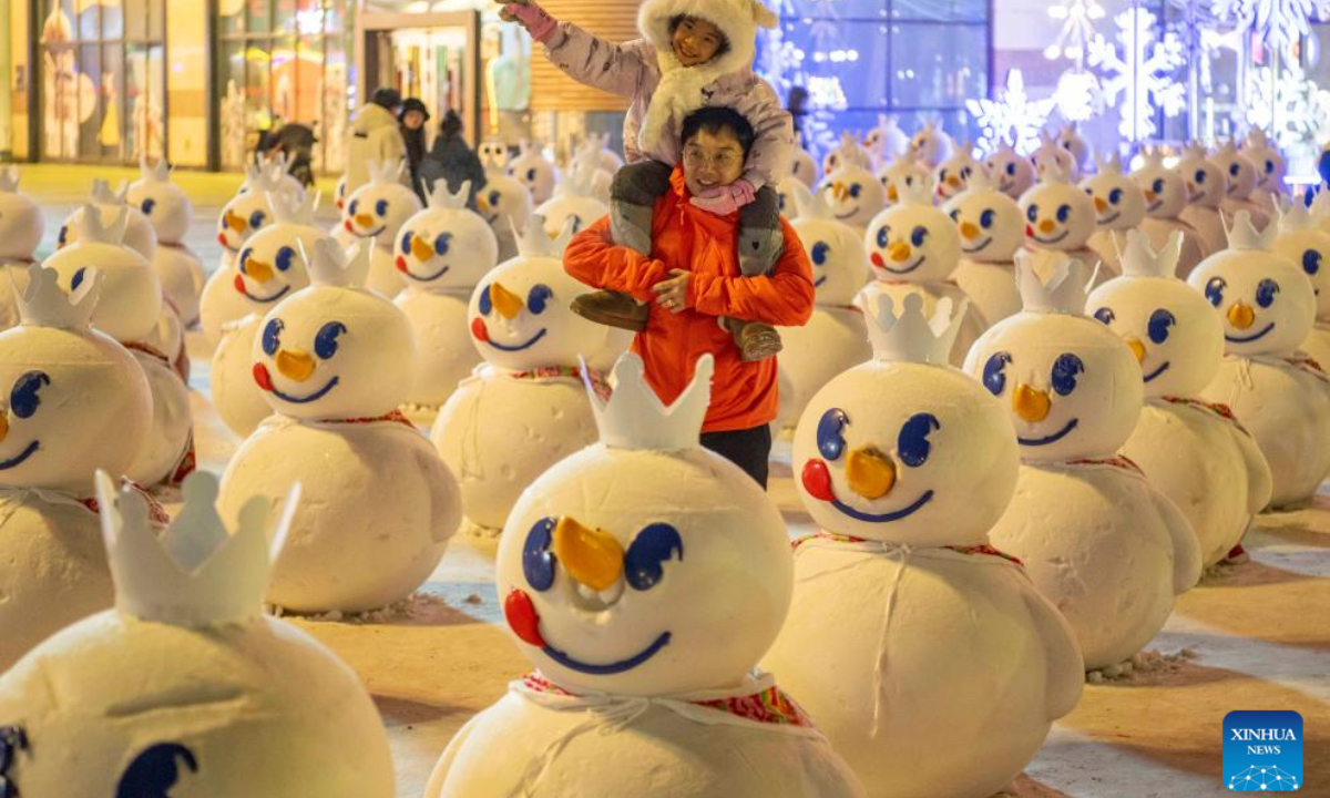 People have fun among snowmen in front of a shopping mall in Harbin, capital of northeast China's Heilongjiang Province, Jan. 3, 2025. Harbin, with many snow sculptures across the city, has emerged as one of China's top winter travel destinations, attracting tourists from around the globe. (Photo: Xinhua)