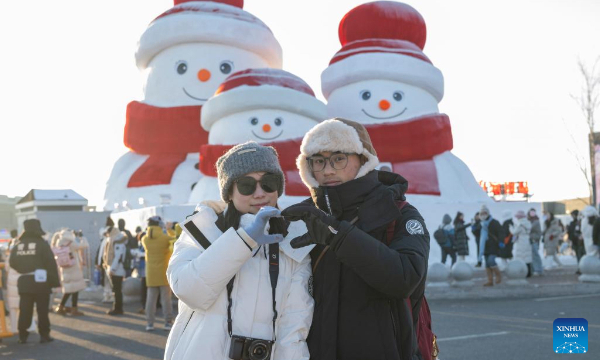 Visitors pose for photos with snowmen at the Harbin Ice-Snow World in Harbin, capital of northeast China's Heilongjiang Province, Jan. 3, 2025. Harbin, with many snow sculptures across the city, has emerged as one of China's top winter travel destinations, attracting tourists from around the globe. (Photo: Xinhua)