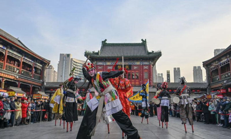 Folk artists perform on stilts at an ancient cultural street in north China's Tianjin Municipality, Jan. 1, 2025. People across China enjoy themselves in various activities, celebrating the first day of 2025. (Xinhua/Sun Fanyue)