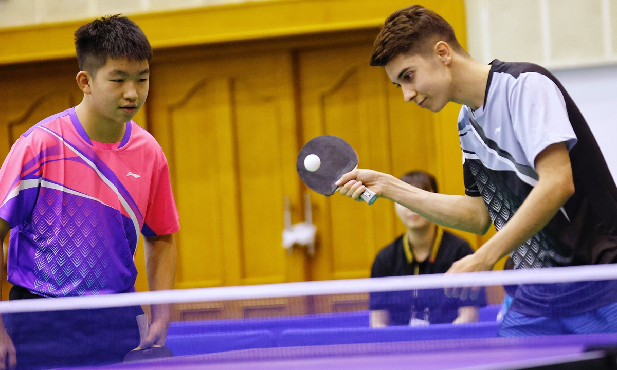 A Chinese boy and his US teammate take part in a table tennis match on July 14, 2024 in Beijing. Photo: VCG