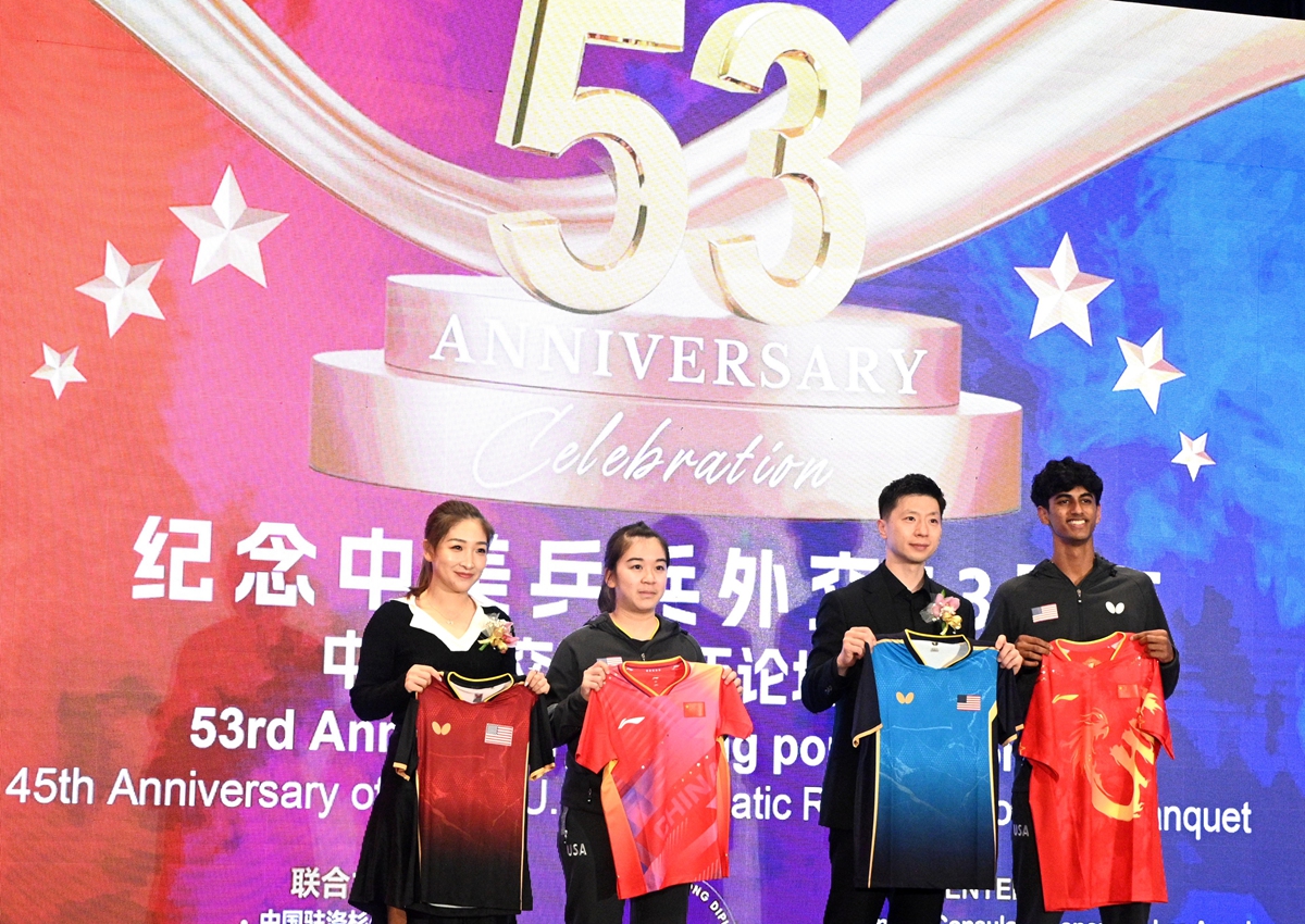 Chinese table tennis stars Liu Shiwen (first from left) and Ma Long (second from right) pose for photos in an event to commemorate the 53rd anniversary of China-US 