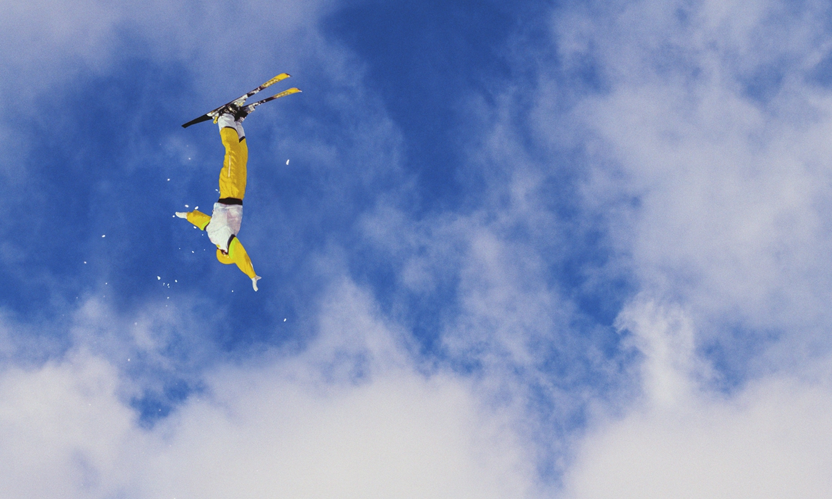 A freestyle aerial skier performs a mid-air flip. Photo: VCG