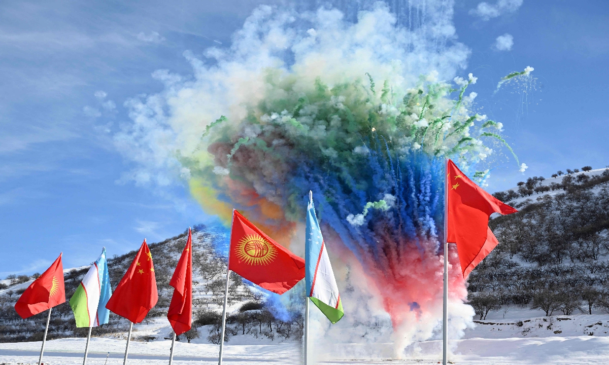 In this handout picture taken and released by the Kyrgyz presidential press office on December 27, 2024, fireworks explode behind state flags during the commencement ceremony of the China-Kyrgyzstan-Uzbekistan railway project in the settlement of Tash-Kitchu. Photo: VCG