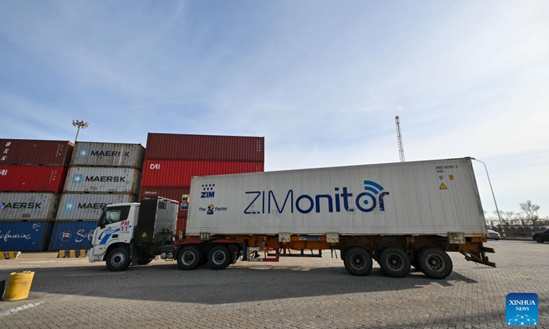 A truck transports newly arrived Chilean cherries to the customs for check at a container terminal of Tianjin Port in north China's Tianjin, Dec. 26, 2024.