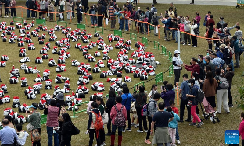 People view giant panda sculptures at Sun Yat Sen Memorial Park in Hong Kong, south China on Dec. 25, 2024. A theme exhibition featuring 2,500 giant panda sculptures was held here on Wednesday. (Xinhua/Lo Ping Fai)