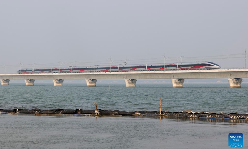 A train passes through the Yuandang Lake section of the Shanghai-Suzhou-Huzhou high-speed railway on Dec. 26, 2024. 