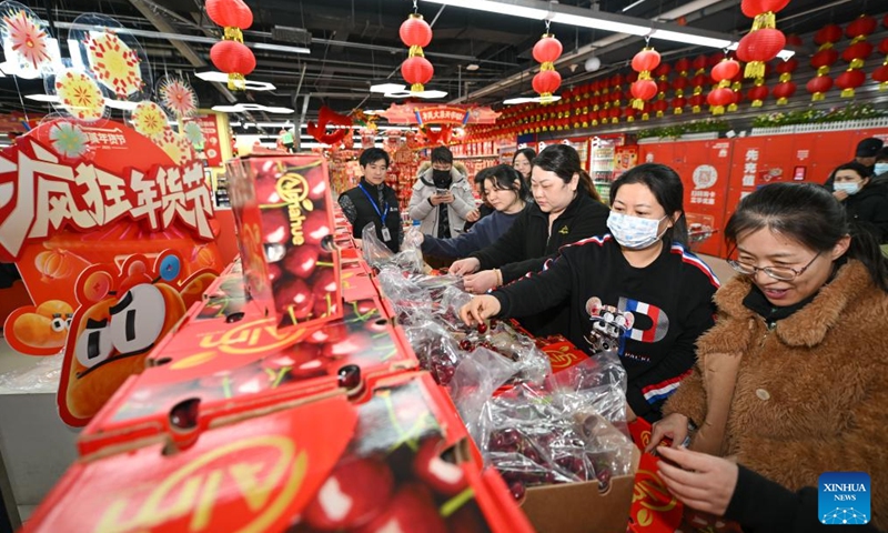 Customers select newly arrived Chilean cherries at a supermarket in Tianjin, north China, Dec. 26, 2024.