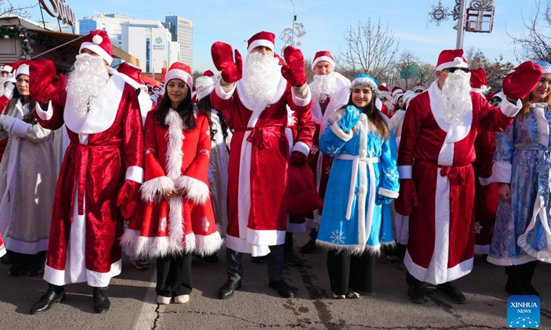 People dressed in costumes celebrate festivals in Tashkent, Uzbekistan, Dec. 25, 2024. (Photo by Zafar Khalilov/Xinhua)