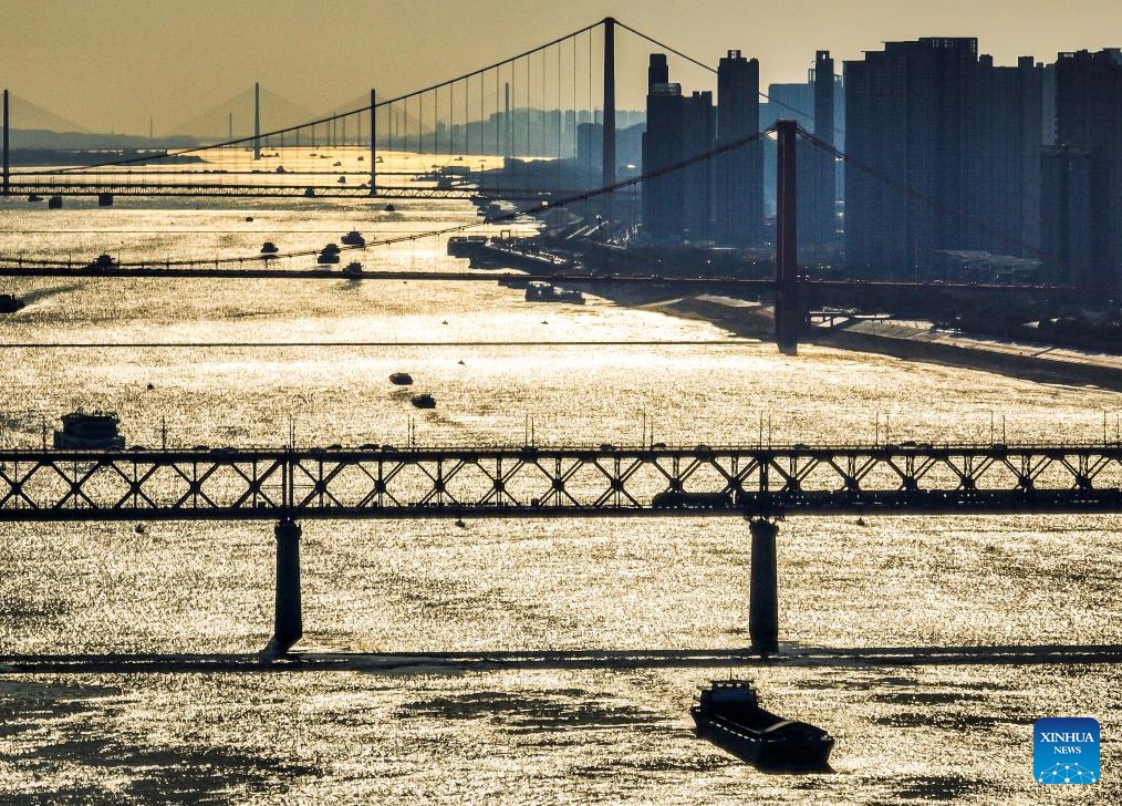 An aerial drone photo take on Jan. 23, 2024 shows ships sailing on the Yangtze River in Wuhan, central China's Hubei Province. Major ports on the Yangtze, China's longest river, are expected to post a total throughput of 4.02 billion tonnes of cargo this year, breaking the mark of 4 billion tonnes for the first time, according to navigation authorities. (Xinhua/Xiao Yijiu)